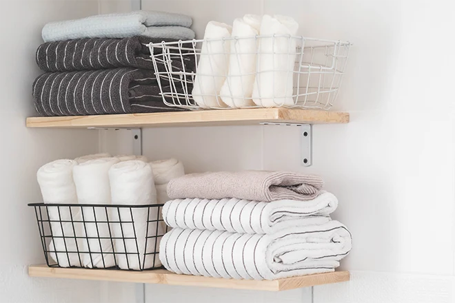Towels and baskets on floating shelves