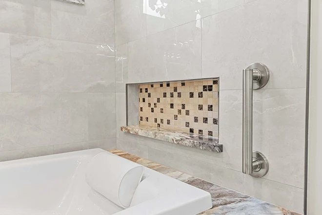 Bathtub that has three different bathroom tile ideas in it