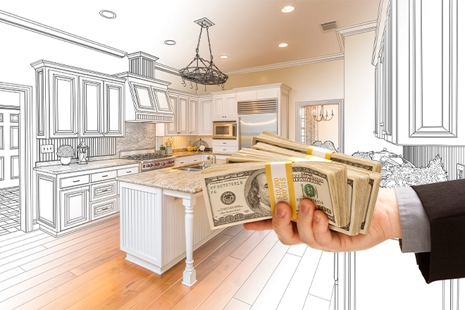 Man holding money in kitchen representing kitchen remodel financing